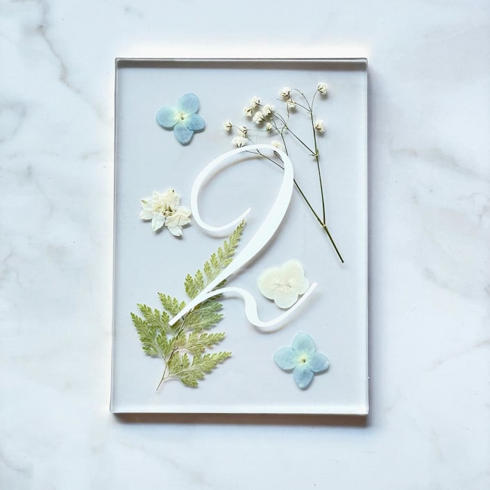 "Gold-Lined Pressed Flower Table Number, Blue" - Table Numbers in red by Jasmine Jhunjhnuwala