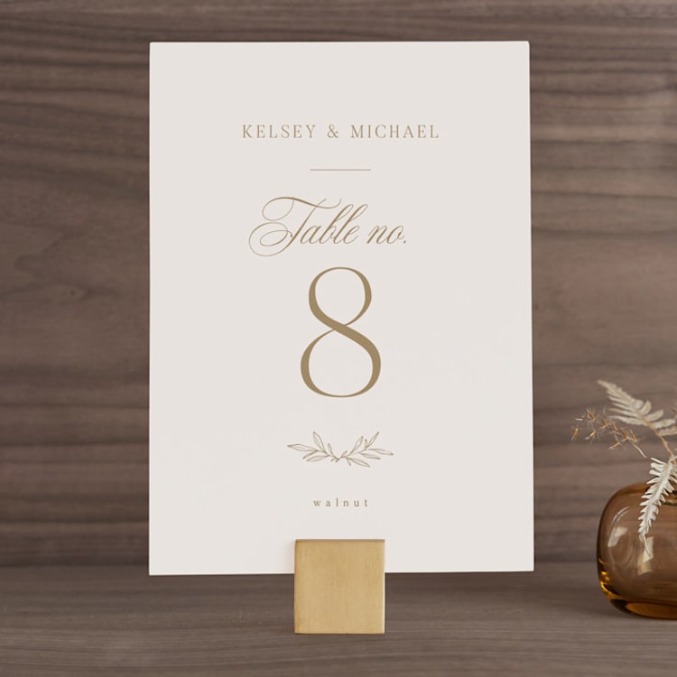 "Emblem" - Table Numbers in Champagne by Everett Paper Goods - Front