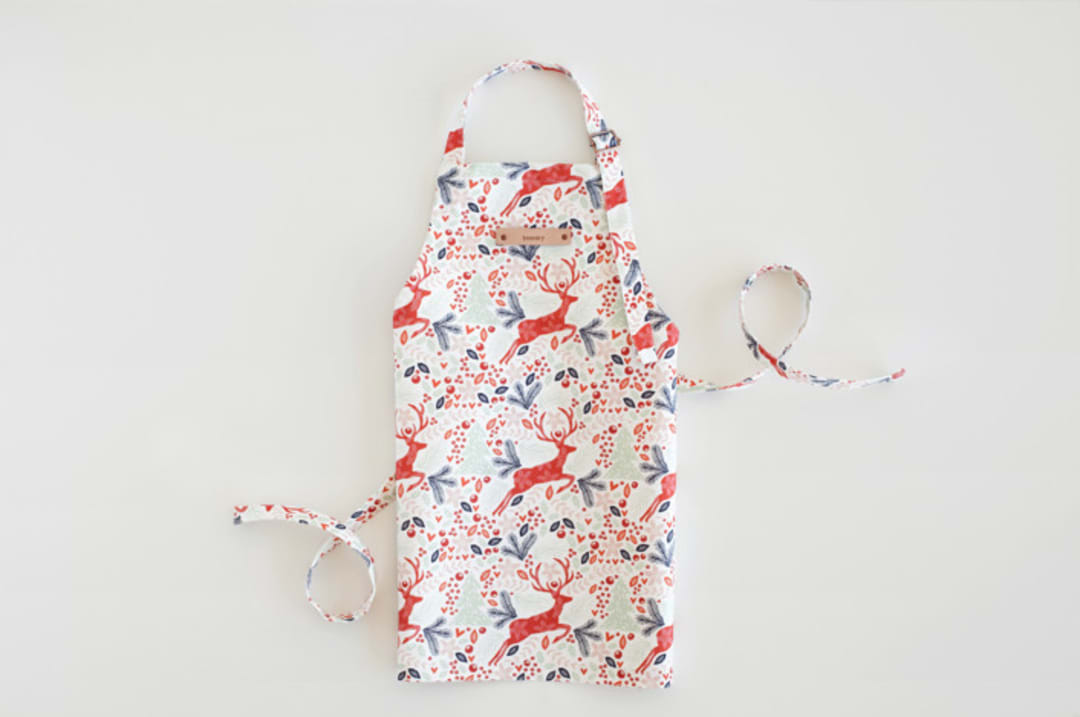 "Jumping Reindeer" - Personalizable Children's Apron in Red by Phrosné Barwood - Personalizable Apron