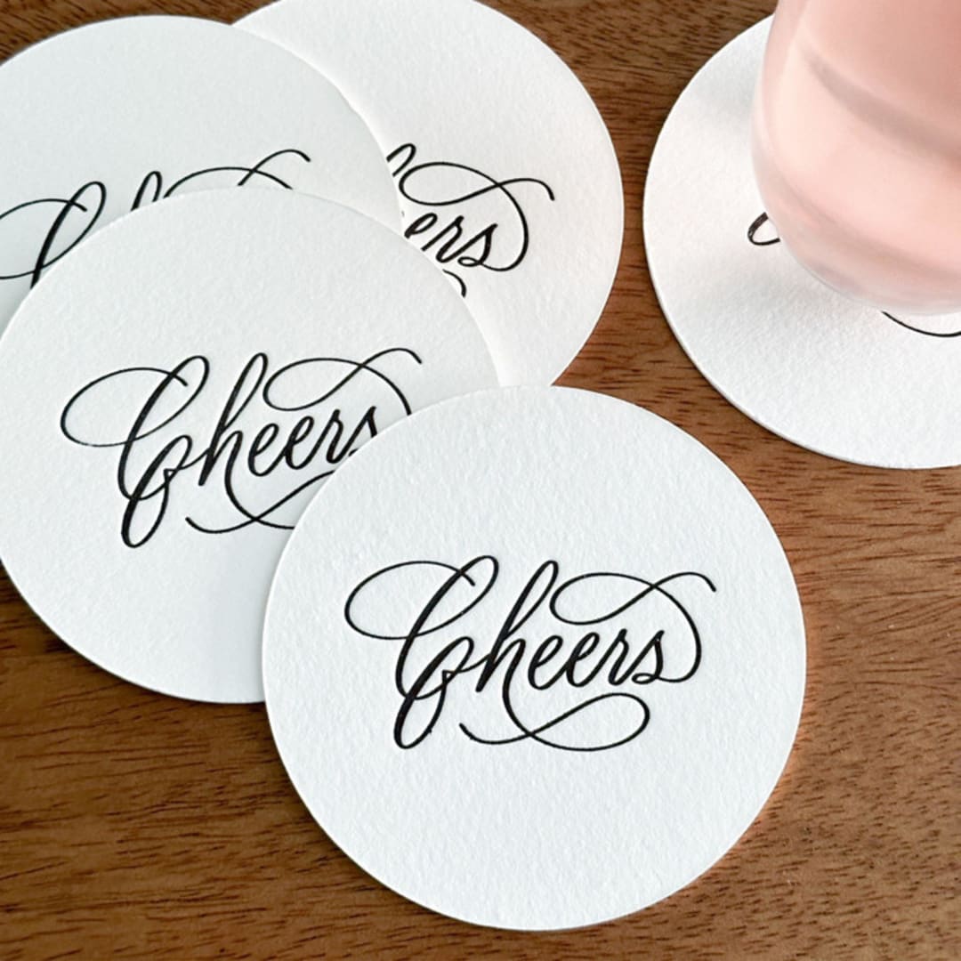 "“Cheers” letterpress disposable paper coasters | Set of 25" - Wedding Coasters in orange by Maria Ferrer G.