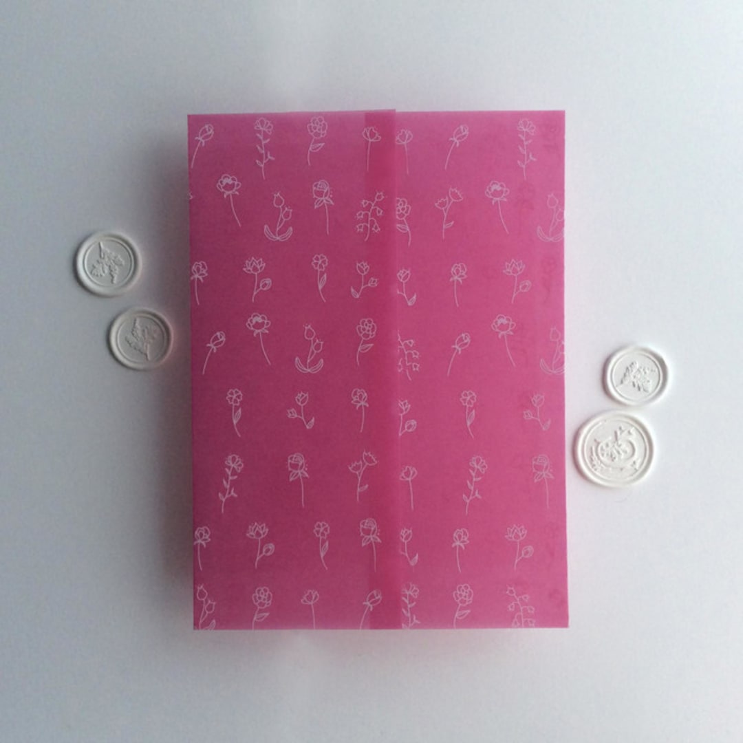 "Minimalist Endless flowers white ink print on pink garnet colored vellum wrap for 5x7 card | pack of 10" - Invitation Jackets and Overlays in pink by Ivory Invitations