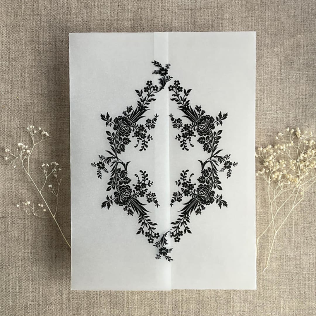 "Black print French floral crest vellum wrap for 5x7 card | pack of 10" - Invitation Jackets and Overlays in black by Ivory Invitations