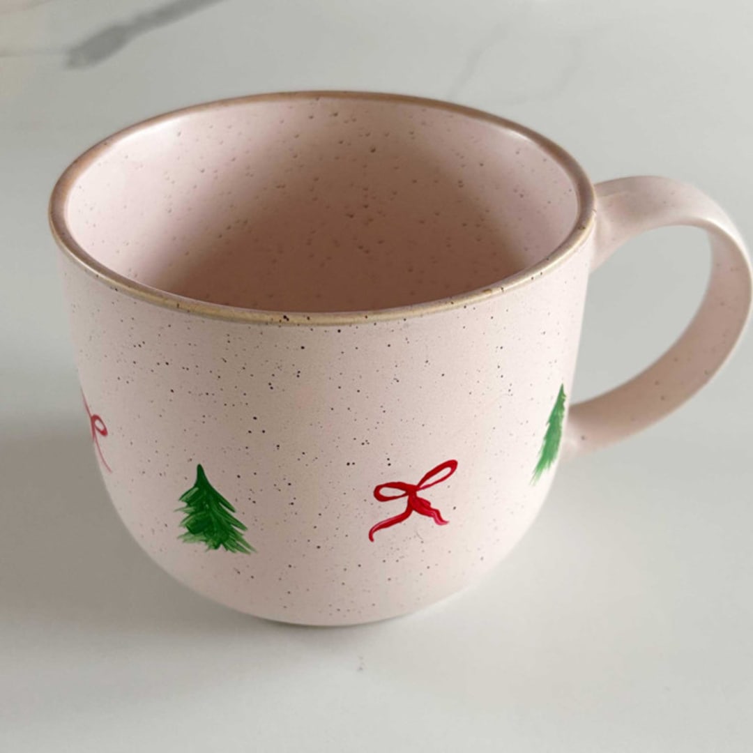 "Hand-Painted Blush Stoneware Mug with Decorative Christmas Bows and Trees, Red and Green" - Mugs and Teacups in pink by Nicoletta Savod