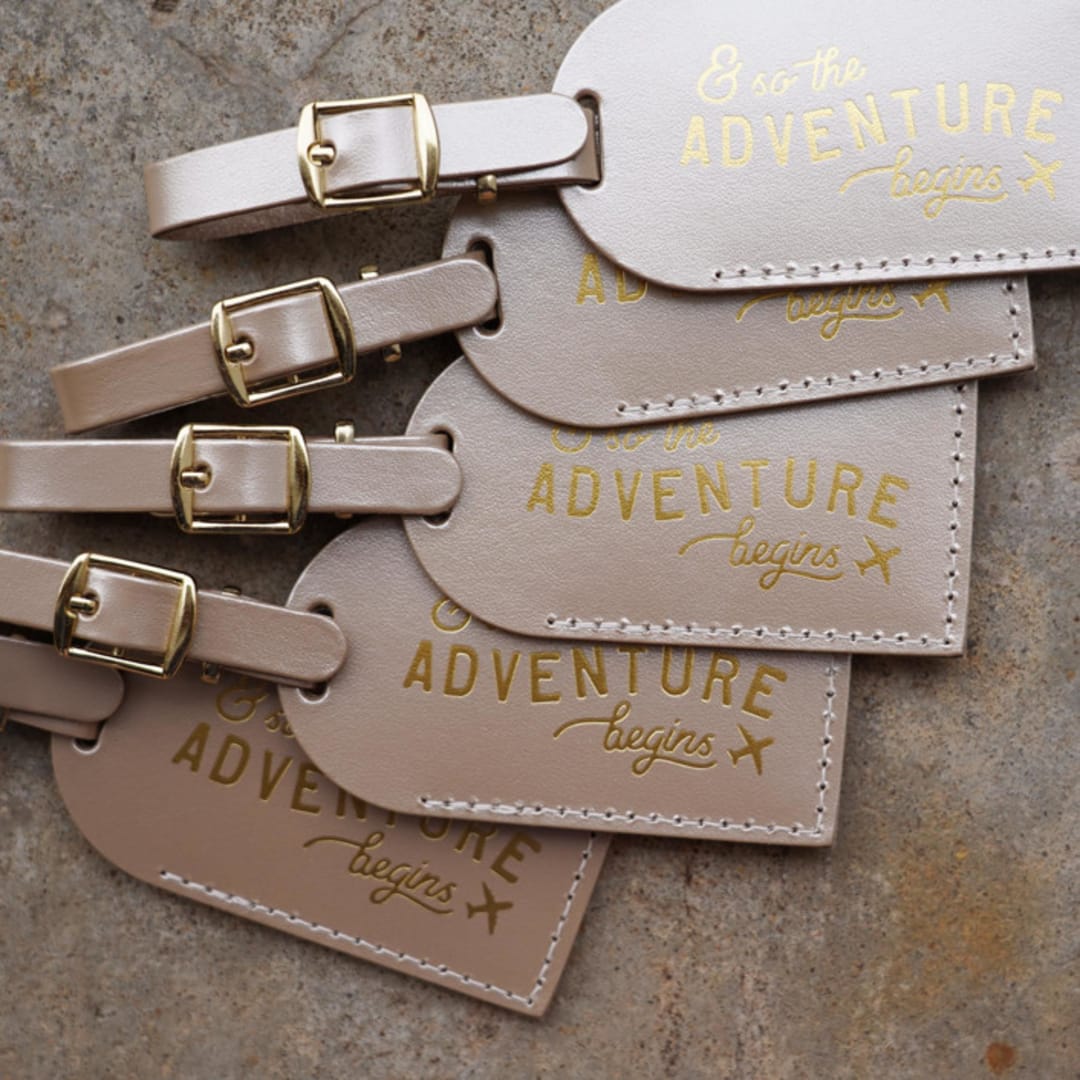 "& So the Adventure Begins Luggage Tags | Champagne, Quantity of 5" - Favors in gold by Melanie Fletcher