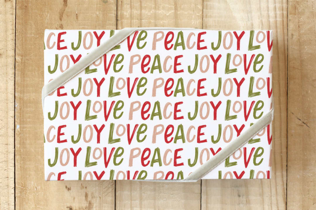"Hand Lettered Joy Love Peace" - Wrapping Paper in Holly Berry by Kristen Magee - Front