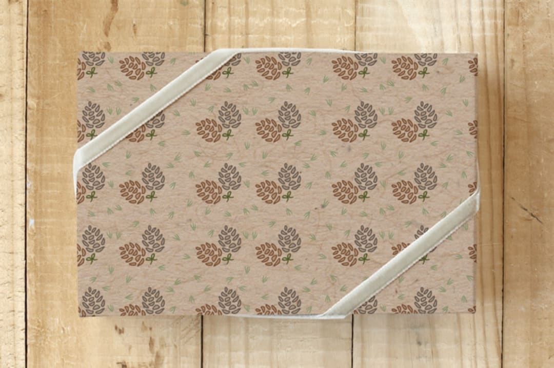 "Krafty Pines" - Wrapping Paper in Pinecone Brown by Amy Ngo - Front