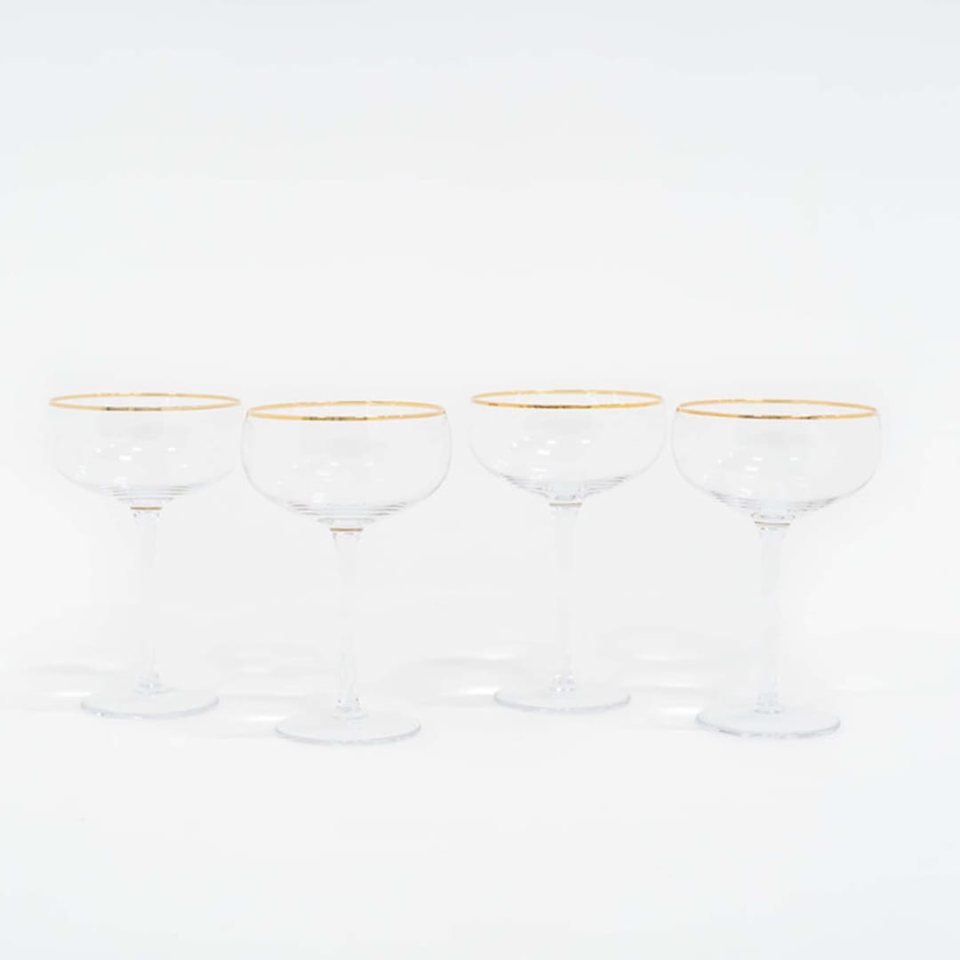 "SET OF 4 - SIREN STEMWARE // CHAMPAGNE COUPE IN CLEAR + GOLD" - Drinkware in clear by borrowed BLU