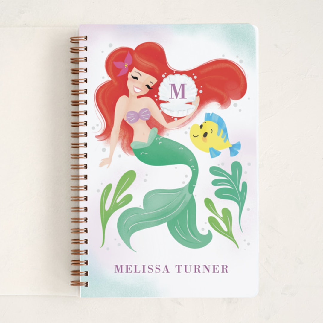 "Disney's Little Mermaid Shellebrate!" - Notebook in Lilac by Sabrin Deirani - Front