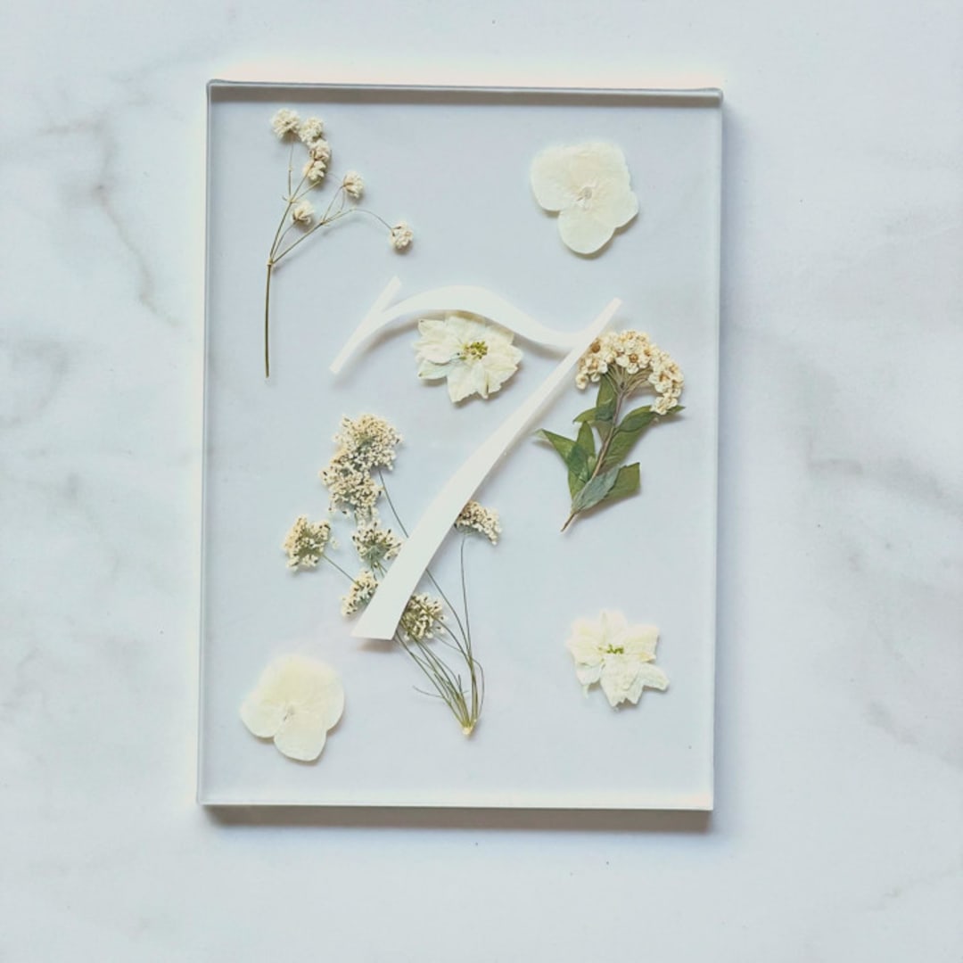 "Silver-Lined Pressed Flower Table Number, White" - Table Numbers in silver by Jasmine Jhunjhnuwala