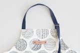"Minimalist circles" - Apron in Navy by Sabrin Deirani - Tag in Bodoni Regular