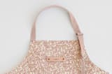 "Animal Dots" - Apron in Tan by Michelle Fifis - Tag in Bodoni Regular