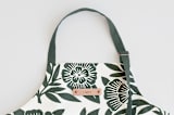 "Block Print Floral" - Apron in Dark Teal by Katharine Watson - Tag in Bodoni Regular