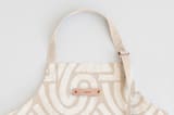 "Antique" - Apron in Sand by Iveta Angelova - Tag in Bodoni Regular