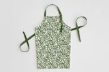 "A Baker's Holiday" - Apron in Sage by Jaclyn Ruble - Apron without personalization