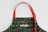 "Holly Branches" - Apron in Holly by Kristen Smith - Tag in Bodoni Regular