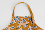 "Wandering" - Apron in Mustard by Alicia Schultz - Tag in Bodoni Regular