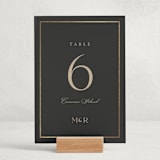 "Timeless Charm" - Foil-Pressed Party Table Numbers in Charcoal by Lucrecia Caporale - Displayed (stand not included)