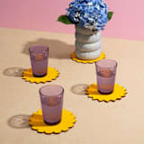"Sunburst Felt Coasters (Set of 4)" - Coasters in yellow by ATELIER SAUCIER