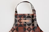 "Sketched Quilt" - Personalizable Children's Apron in Rust by Alethea and Ruth - Tag in Bodoni Regular