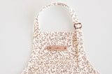 "Enchanted Holiday" - Personalizable Children's Apron in Cinnamon by Teju Reval - Tag in Bodoni Regular