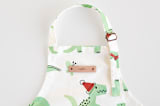 "Darling Dinos" - Personalizable Children's Apron in Mint by Jessie Steury - Tag in Bodoni Regular