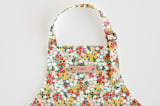 "Field of Florals" - Personalizable Children's Apron in Scarlet by Kelsey Carlson - Tag in Bodoni Regular