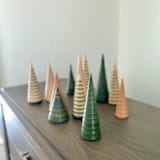 "The Fir Forest- 12 unique trees in four heights with three finishes" - Decorative Object in green by Ann Nygard