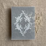 "French floral crest white ink print vellum overlay for 5x7 card | pack of 10" - Invitation Jackets and Overlays in white by Ivory Invitations