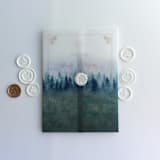 "Rustic Blue ombre forest landscape printed vellum wrap for 5x7 card  | pack of 10" - Invitation Jackets and Overlays in blue by Ivory Invitations