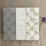 "Festive ribbon bow lattice hazelnut printed vellum wrap for 5x7 card | pack of 10" - Invitation Jackets and Overlays in beige by Ivory Invitations