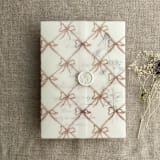 "Festive ribbon bow lattice rosy pink printed vellum wrap for 5x7 card | pack of 10" - Invitation Jackets and Overlays in pink by Ivory Invitations