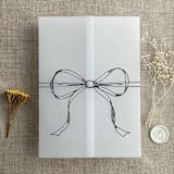 "Black ribbon bow printed vellum wrap for 5x7 card | pack of 10" - Invitation Jackets and Overlays in black by Ivory Invitations