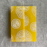 "White ink printed citrus celebration yellow vellum wraps for 5x7 card | pack of 10" - Invitation Jackets and Overlays in yellow by Ivory Invitations