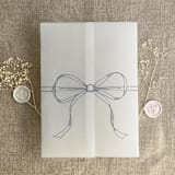 "Steel blue ribbon bow printed vellum wrap for 5x7 card | pack of 10" - Invitation Jackets and Overlays in blue by Ivory Invitations
