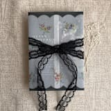 "Clara black scallop floral edge printed vellum wrap for 5x7 card | pack of 10" - Invitation Jackets and Overlays in black by Ivory Invitations