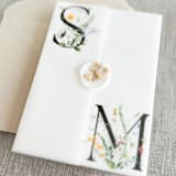 "Couple's initials with wildflowers vellum wraps for 5x7 invitations | Set of 10" - Invitation Jackets and Overlays in multicolorassorted-colors by Maria Ferrer G.