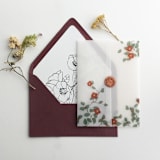 "Red velvet Camellia floral branch printed vellum wrap for 5x7 card  | pack of 10" - Invitation Jackets and Overlays in red by Ivory Invitations