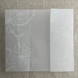 "White poinsettia vellum wrap for 5x7 card | pack of 10" - Invitation Jackets and Overlays in white by Ivory Invitations