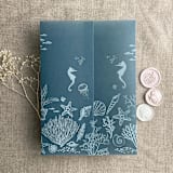 "Under the sea white ink printed on steel blue colored vellum wrap for 5x7 card  | pack of 10" - Invitation Jackets and Overlays in blue by Ivory Invitations