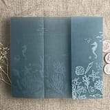 "Under the sea white ink printed on steel blue colored vellum wrap for 5x7 card  | pack of 10" - Invitation Jackets and Overlays in blue by Ivory Invitations