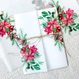 "Poinsettia & Pinecones Vellum Jacket | Set of 10" - Invitation Jackets and Overlays in green by Megan Tendler