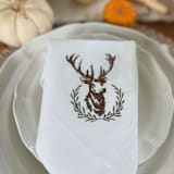 "Dinner Napkin with Embroidered Deer Stag Wreath" - Napkins in brown by Virginia Marcello