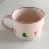 "Hand-Painted Blush Stoneware Mug with Green Christmas Trees and Dainty Red Bows" - Mugs and Teacups in pink by Nicoletta Savod