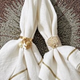 "Coral and shell skinny napkin rings, cream, set of four" - Tabletop Accessories in gold by Joanna Buchanan