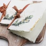 "Gold Gilded Mountain Vow Book | Set of 2 | Size 6x4.125" - Wedding Vow Books in multicolor by Clove and Cedar Design