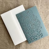 "Dust Blue Lace Lasercut Pocket | Pack of 10 | Envelopes Included" - Invitation Pockets in blue by Ivory Invitations