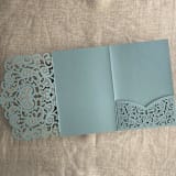 "Dust Blue Lace Lasercut Pocket | Pack of 10 | Envelopes Included" - Invitation Pockets in blue by Ivory Invitations