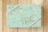 "Joyeux Noel Starburst" - Wrapping Paper in Mint Green by Erika Firm - Front