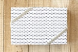 "petite polka dot" - Wrapping Paper in black by Jen Owens - Front