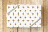 "Bright Stars" - Wrapping Paper in Golden by Nicole Barreto - Front